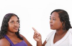 mother warn her daughter for bad behavior, isolated on white